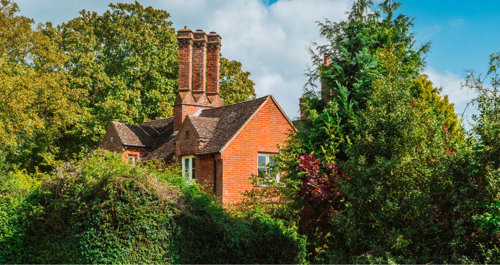 Large red brick house in the trees in the UK
