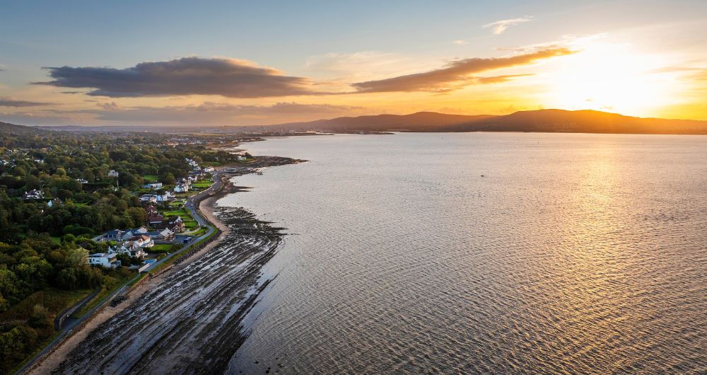 Cultra coastline with sunset over mountains