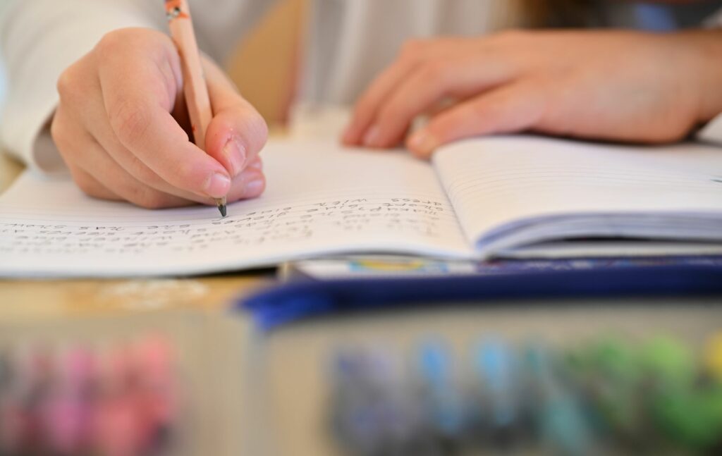 Schools in Northern Ireland: Pupil writing with pencil